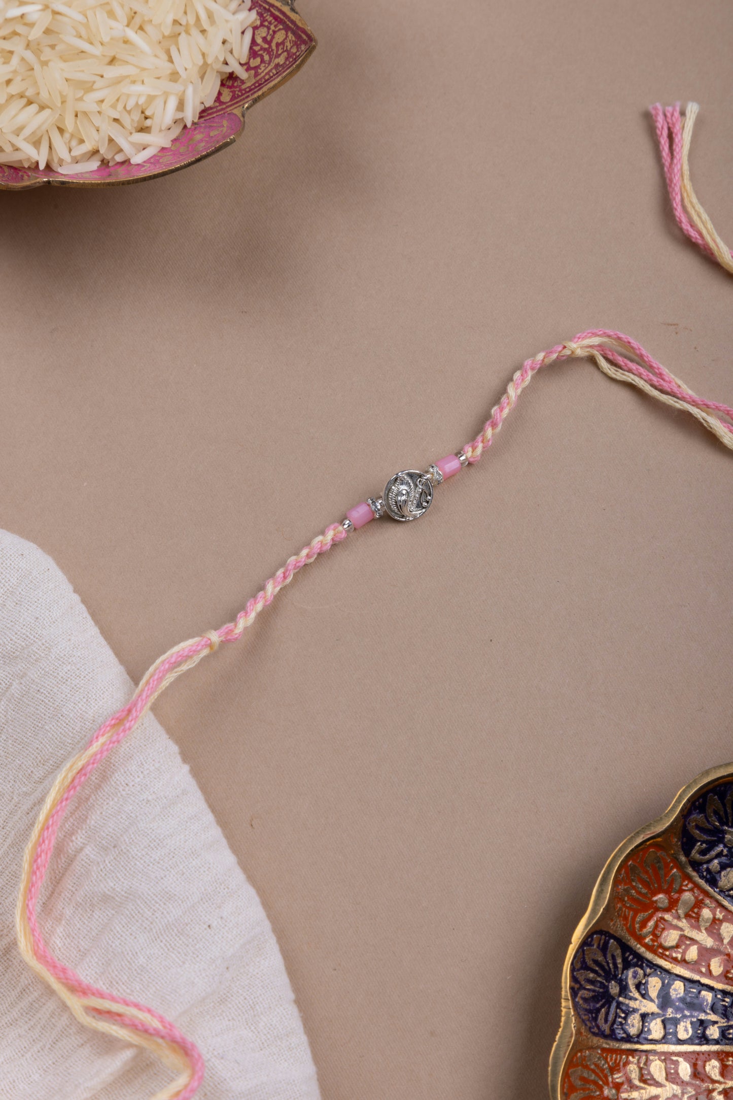 Pink feather coin rakhi