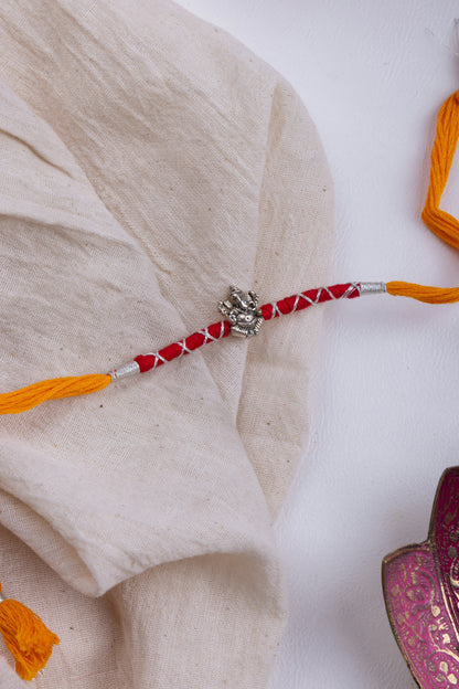 Ganesha red & orange thread rakhi