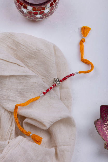 Ganesha red & orange thread rakhi