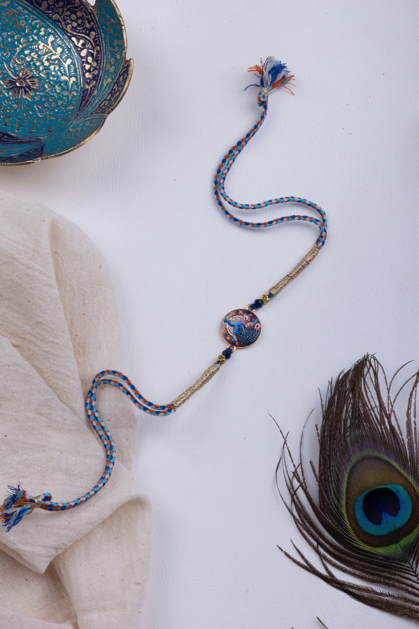 Peacock pichwai thread weave rakhi