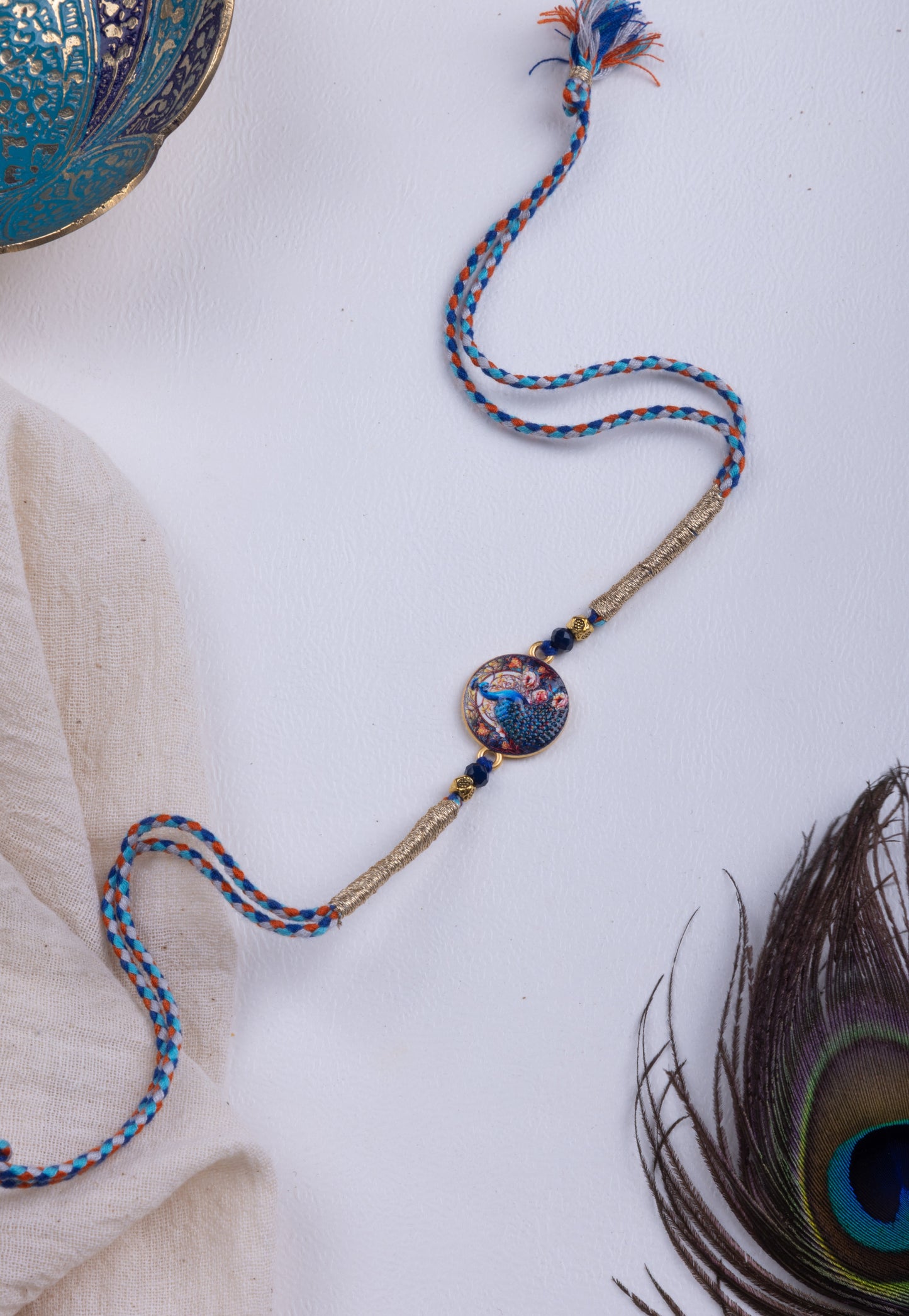 Peacock pichwai thread weave rakhi