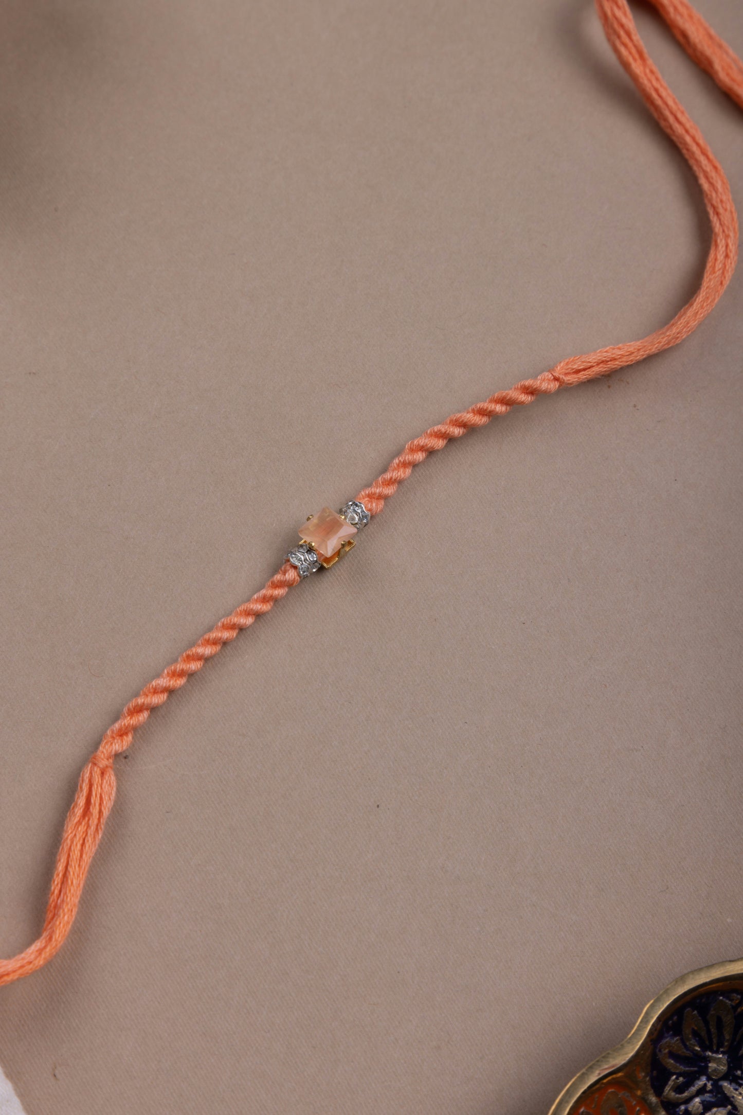Orange crystal rakhi