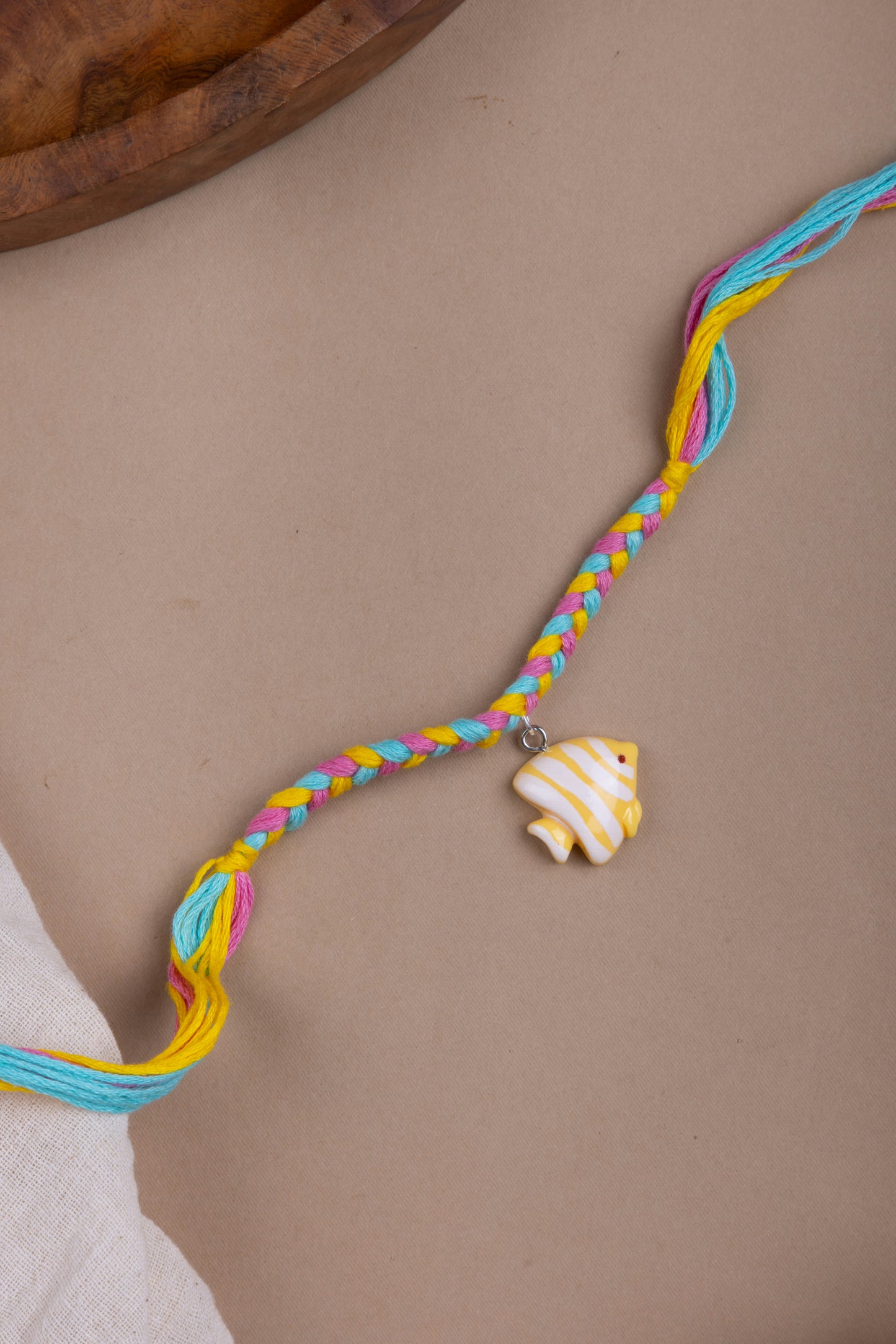 Fish charm pastel thread rakhi