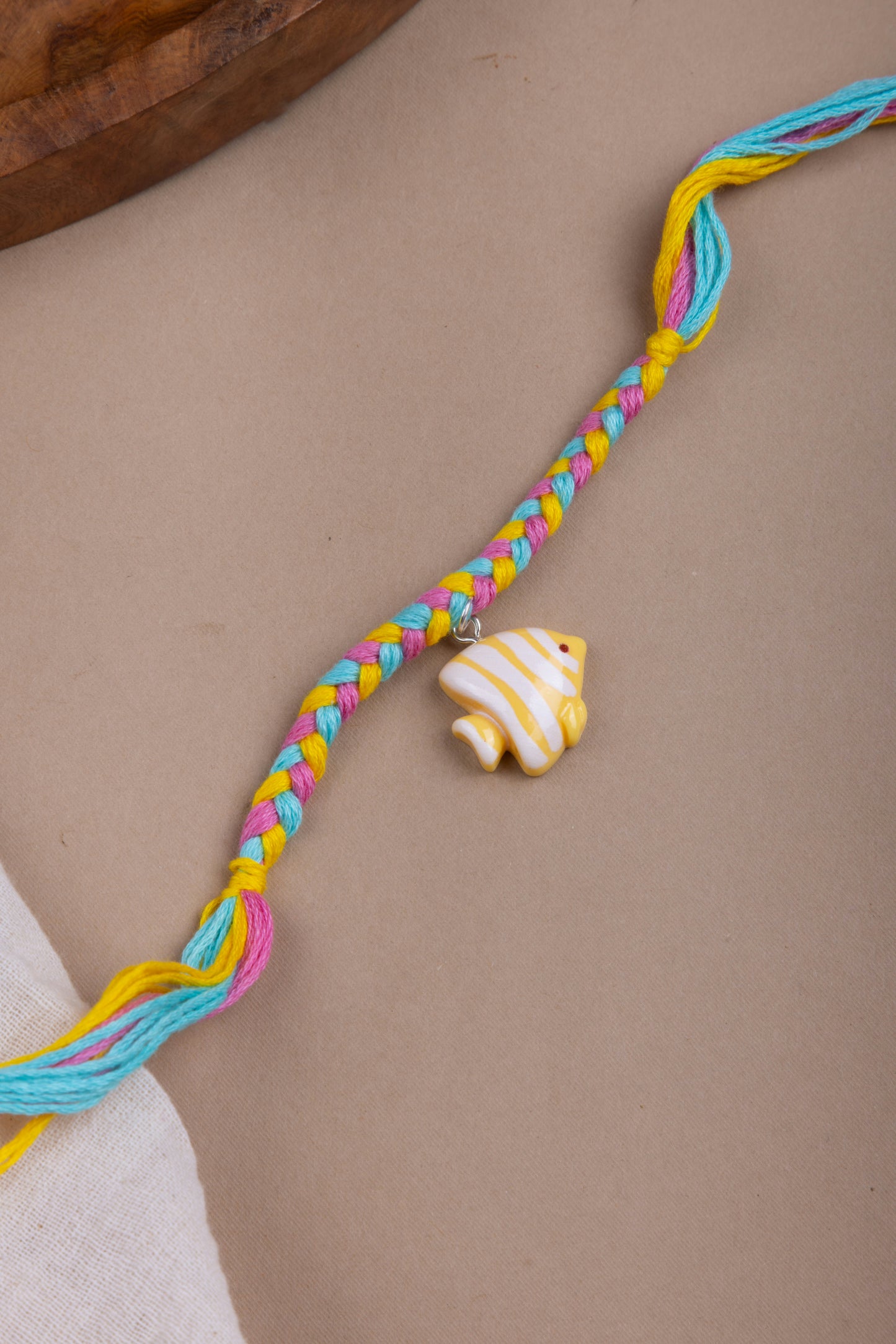 Fish charm pastel thread rakhi
